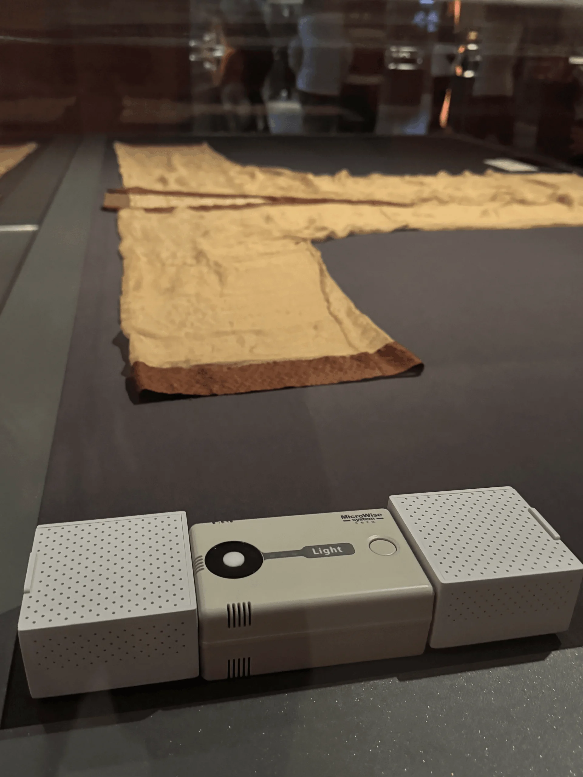 A view of a display case housing a Han Dynasty silk robe, integrated with a light, temperature, and humidity monitoring system to ensure an optimal environment for the preventive conservation of the cultural object, on February 7, 2025. Photograph by CHEN Zoe.