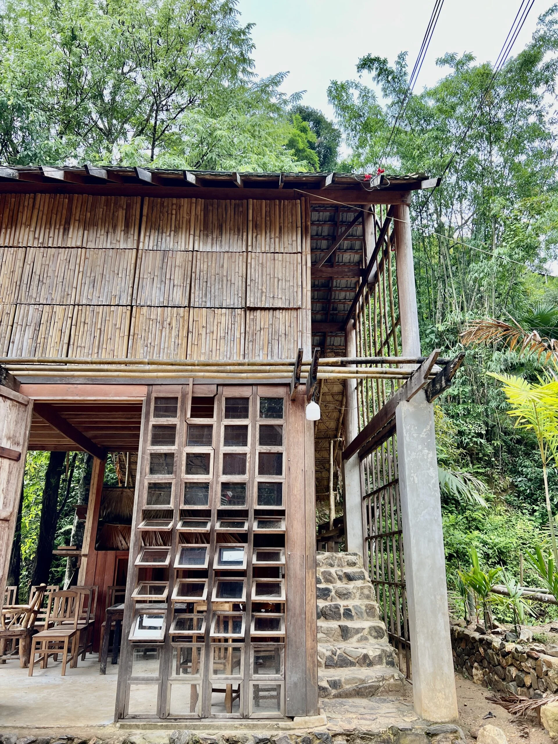 A wooden building with an enclosed section at the top and open air with no walls underneath.